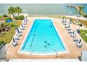 Beautiful pool with plenty of seating and umbrellas for shade on a brick pool deck at 10215 Regal Dr # 41, Largo, FL 33774