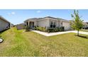 Well-kept single Gathering home with manicured lawn and garden beds highlighting the walkway and driveway at 105 Blue Alice Spring Ct, Ruskin, FL 33570