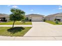 Classic home exterior with a well-maintained lawn and driveway, showcasing a welcoming and pristine curb appeal at 105 Blue Alice Spring Ct, Ruskin, FL 33570