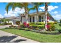 Inviting single-story home showcasing lush landscaping, a well-manicured lawn, and a side-entry garage at 11743 Lake Lucaya Dr, Riverview, FL 33579