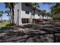 Exterior of the property with garage and reserved parking with mature palms at 12140 Capri S Cir # 709, Treasure Island, FL 33706