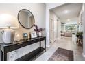 Welcoming entryway with stylish console table, decorative mirror, and neutral decor at 13061 Brookside Moss Dr, Riverview, FL 33579