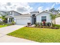 Inviting home exterior with a landscaped front yard and a spacious driveway at 13061 Brookside Moss Dr, Riverview, FL 33579