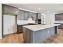 Modern kitchen featuring stainless steel appliances, granite countertops, and a spacious center island at 13631 Sunlight Meadow Dr, Riverview, FL 33578