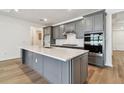 Kitchen boasts a large center island, stainless steel appliances and ample storage space at 13631 Sunlight Meadow Dr, Riverview, FL 33578