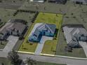 An aerial view of the home showcasing its landscaped yard and architectural design in a suburban setting at 13805 Carryback Dr, Dade City, FL 33525