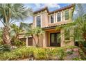 Charming two-story home featuring a two-car garage and landscaped yard with double door entrance at 20347 Chestnut Grove Dr, Tampa, FL 33647