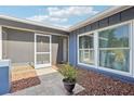 Inviting front entry with tile flooring and a screen door for added comfort and ventilation at 206 Timberview Dr, Safety Harbor, FL 34695