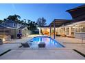 Stunning backyard oasis with a sleek pool, modern pergola, and stylish lounge area at 222 N Clearview Ave, Tampa, FL 33609