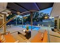 Inviting backyard featuring a pool, lounge area, fire pit, and modern outdoor lighting at 222 N Clearview Ave, Tampa, FL 33609