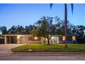 Traditional brick home with a well-kept lawn, mature tree, and inviting curb appeal at 222 N Clearview Ave, Tampa, FL 33609