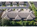 Aerial view of multi-unit dwelling showcasing roof and surrounding landscape within a well maintained community at 2527 Silverback Ct, Palm Harbor, FL 34684
