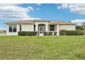 Charming single-story home with a well-maintained lawn and verdant shrubbery at 2602 Novack Ct, Sun City Center, FL 33573