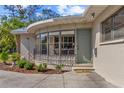 Close-up showcasing the home's entryway, complete with a charming rounded window and manicured landscaping at 300 22Nd S Ave, St Petersburg, FL 33705