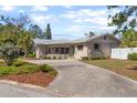 Attractive home boasting a unique roofline, mature landscaping, and a spacious driveway leading to the entrance at 300 22Nd S Ave, St Petersburg, FL 33705