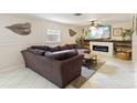 Cozy living room with a fireplace, mounted TV, and a large sectional sofa at 3176 Duane Ave, Oldsmar, FL 34677