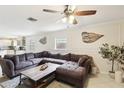 Comfortable living room with plush sectional sofa, ceiling fan, and stylish wall decor at 3176 Duane Ave, Oldsmar, FL 34677