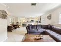 Open-concept living room with tile flooring, modern decor, and a view of the kitchen at 3176 Duane Ave, Oldsmar, FL 34677