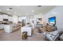 Open-concept living space featuring a modern kitchen, comfortable seating, and stylish accents at 32434 Osprey Peak Way, San Antonio, FL 33576