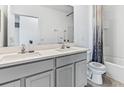 Clean, modern bathroom with double sinks, contemporary fixtures and shower/tub combo at 33091 Osprey Peak Way, San Antonio, FL 33576