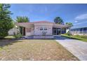 Inviting single-story home with a carport, featuring colorful shutters and a tidy front yard at 35128 Dale Ave, Zephyrhills, FL 33541