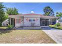 Cozy single-story home with a covered carport, charming shutters, and a well-maintained lawn at 35128 Dale Ave, Zephyrhills, FL 33541