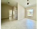 Bright living room with neutral walls, a ceiling fan, tile flooring and natural light with vaulted ceiling at 3944 102Nd N Pl, Clearwater, FL 33762