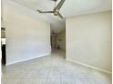 Open-concept living room with tile flooring, neutral walls, and a ceiling fan that connects to other rooms at 3944 102Nd N Pl, Clearwater, FL 33762
