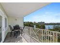 Spacious balcony with outdoor seating and panoramic views of the water and surrounding area at 399 C 2Nd St # 313, Indian Rocks Beach, FL 33785