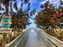 Inviting beach access path with lush greenery and scenic views of the ocean at 399 C 2Nd St # 313, Indian Rocks Beach, FL 33785