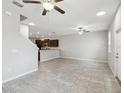 Open-concept space featuring modern tile floors, ceiling fans, with a kitchen view for easy entertaining at 4183 Ballantrae Blvd, Land O Lakes, FL 34638