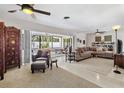Bright living room with neutral colors, ceiling fans, and a view of the outdoors at 4340 50Th S Ter, St Petersburg, FL 33711