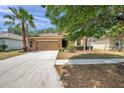 Charming home with well-manicured landscaping, large driveway, and a two-car garage at 4500 Fieldview Cir, Wesley Chapel, FL 33545