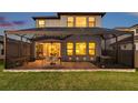 Screened-in patio with outdoor seating, dining area, and well-maintained lawn, perfect for relaxing and entertaining at 4719 Tramanto Ln, Wesley Chapel, FL 33543