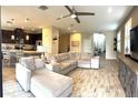 Spacious living room open to the kitchen, featuring a large sectional and plenty of natural light at 4744 Wandering Way, Wesley Chapel, FL 33544