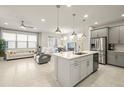 Bright and airy kitchen and living area with pendant lighting and modern stainless steel appliances at 5733 Colony Glen Rd, Lithia, FL 33547