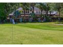 Expansive backyard with a well-manicured lawn and mature trees surrounding a beautiful home at 6352 W Maclaurin Dr, Tampa, FL 33647