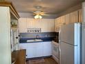 Kitchen with white cabinets, blue countertops, and updated appliances at 8320 112Th St # 206, Seminole, FL 33772