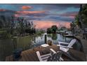 Inviting waterfront view from the private dock with charming seating and a peaceful canal setting at 8702 Driftwood Dr, Tampa, FL 33615