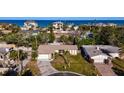 Ariel shot of quaint house, palm trees, and beach homes near ocean at 920 Palm Dr, Belleair Beach, FL 33786