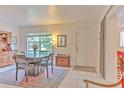 Cozy dining room features a decorative rug, tile flooring, and a large window with natural light at 10119 Cliff Cir, Tampa, FL 33612
