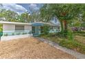 Charming one-story home with unique architecture, stylish awning, and gravel landscaping at 10119 Cliff Cir, Tampa, FL 33612