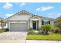 Charming single Gathering home featuring manicured landscaping and a two-car garage at 10729 Planer Picket Dr, Riverview, FL 33569