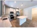 Modern kitchen with stainless steel appliances and center island at 10729 Planer Picket Dr, Riverview, FL 33569