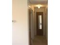 Hallway with white walls, neutral flooring and three closed doors leading to other rooms of the home at 1146 Alma St, Clearwater, FL 33756