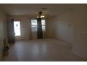 Spacious living room with neutral walls, ceiling fan and a large window with dark curtains at 1146 Alma St, Clearwater, FL 33756