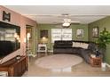 Cozy living room featuring unique flooring, complemented by a ceiling fan and a comfortable seating arrangement at 12213 Floral Ln, Thonotosassa, FL 33592