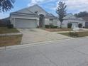 Well-kept single-Gathering home with attached two-car garage and a concrete driveway at 13231 Cherry Bark Cir, Riverview, FL 33579