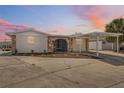 Charming single-story home featuring stone accents, a carport, and well-maintained landscaping for curb appeal at 13810 Malcolm Ave, Hudson, FL 34667