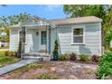 Inviting exterior view of a cozy home with mature landscaping, enhancing its appeal and charm at 1419 55Th S St, Gulfport, FL 33707